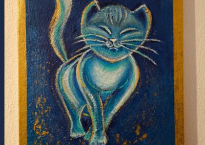 Blau gemalte Katze mit geschlossenen Augen und ruhiger Ausstrahlung